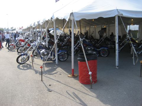 1986 Ford Bronco - A row of custom motorcycles displayed under a large tent at an outdoor event.