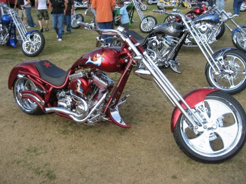 1986 Ford Bronco - Custom chopper motorcycle with elaborate paintwork and chrome details is displayed at an outdoor event.