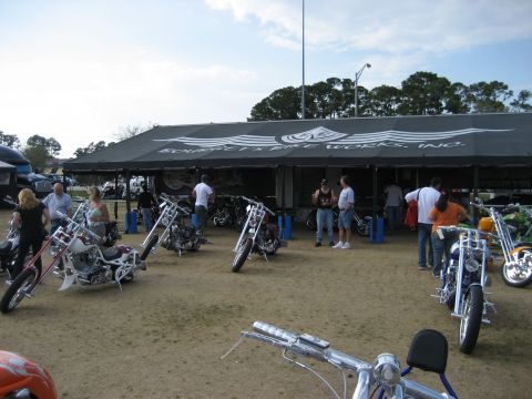 1986 Ford Bronco - Several custom motorcycles are displayed outside a tent at an event.