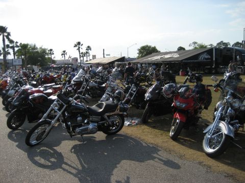 1986 Ford Bronco - A large gathering of motorcycles parked outdoors, with tents and structures suggesting an event.