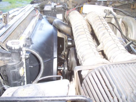 1994 Ford F-150 - Close-up view of the radiator and electric fan assembly within the engine compartment.