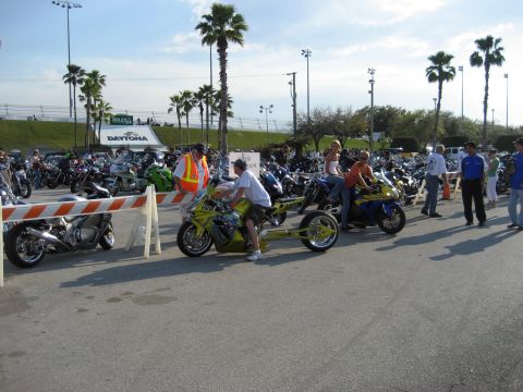 1986 Ford Bronco - A large gathering of motorcycles are parked at Daytona International Speedway under a clear sky.