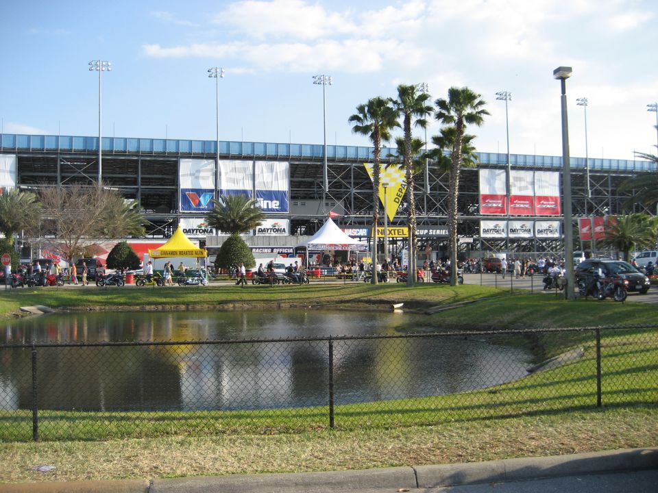 Daytona International Speedway with tents and palm trees