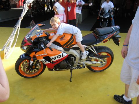1986 Ford Bronco - A young boy poses on an orange and black sport motorcycle, with other people and motorcycles in the background.