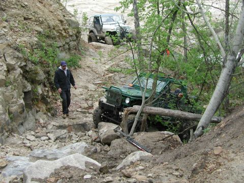 1992 Ford Bronco - Two SUVs tackle a challenging rocky trail during an off-road excursion.