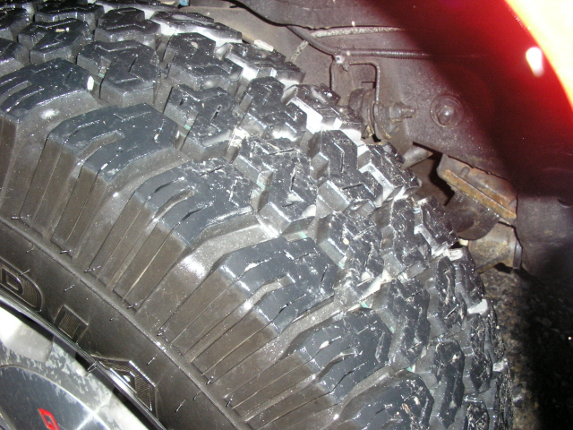 Close-up of a knobby off-road tire with water droplets