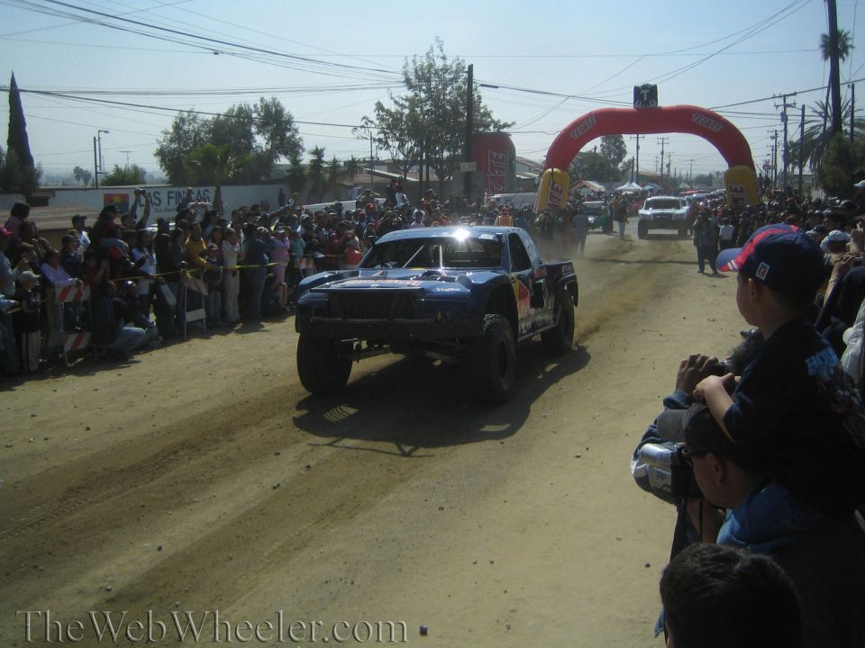 Dark blue Red Bull sponsored off-road race truck on a dirt course
