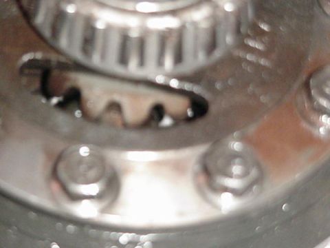 1992 Ford Bronco - A close-up view of a toothed gear and a pulley, likely from a vehicle's engine.