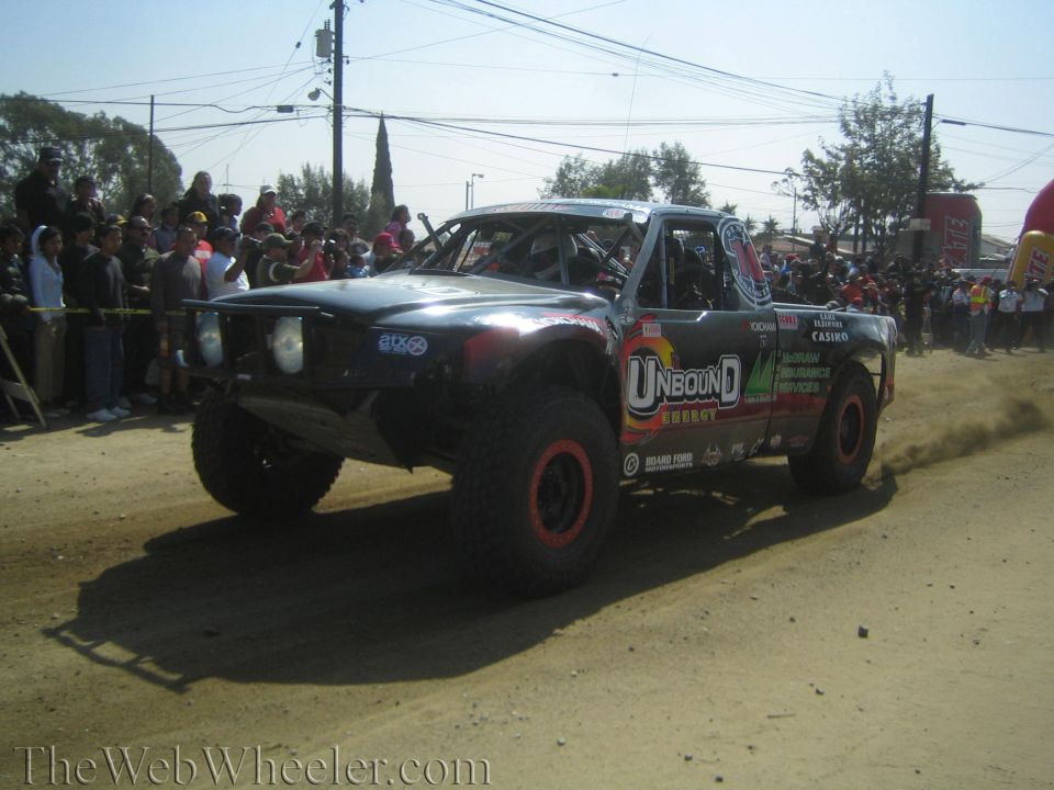 Black Unbound Energy sponsored off-road race truck on a dirt course