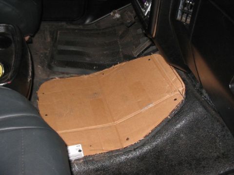 1991 Ford Bronco - A custom-cut cardboard floor mat is placed on the vehicle's floor.