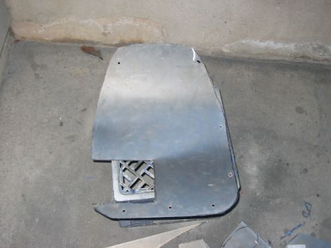 1991 Ford Bronco - A detached metal panel, possibly a fender liner or underbody shield, is shown with a cut-out vent.