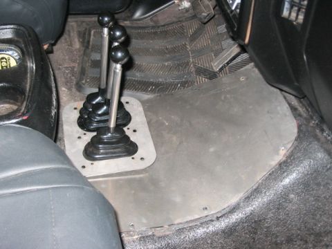 1991 Ford Bronco - The interior floor shows a dual shifter setup and a metal plate covering the transmission tunnel.