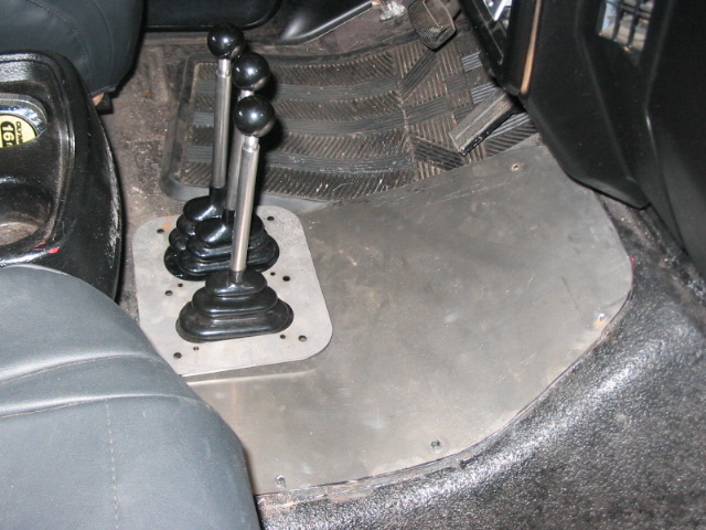 Interior floor with dual shifters and metal plate