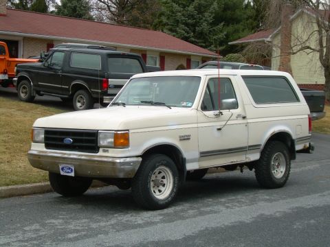1988 Ford Bronco - This 1988 Ford Bronco is parked in front of a house with another Bronco behind it.