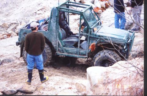 1992 Ford Bronco - fixing the rear driveshaft. me laying under it.