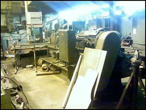 1996 Ford F-150 - A workshop scene industrial machinery, including a Marvel band saw and other equipment, with a "SUPERMOTORS" watermark at the bottom.