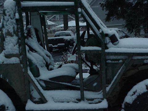 1992 Ford Bronco - Snowfall blankets a vehicle's interior and exterior, with a second vehicle parked behind.