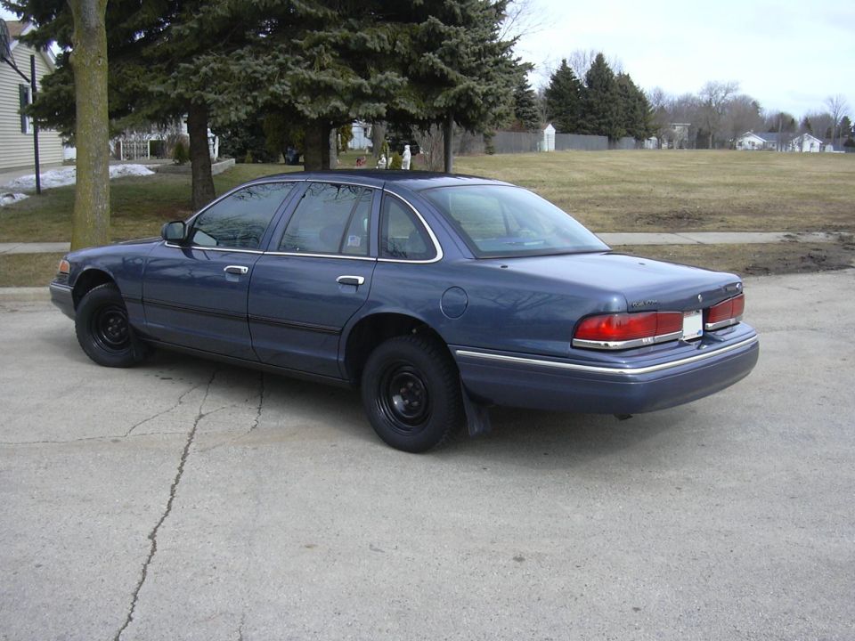Blue sedan, rear 3/4 view. 1995 Ford Crown Victoria