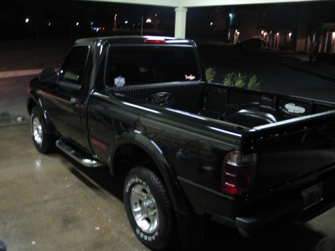 2003 Ford Ranger - Black 2003 Ford Ranger pickup truck seen from the rear 3/4 angle.
