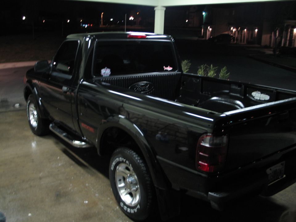 Black 2003 Ford Ranger pickup truck, rear 3/4 view