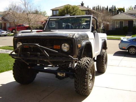 1971 Ford Bronco - Modified 1971 Ford Bronco parked in a driveway with houses in the background.