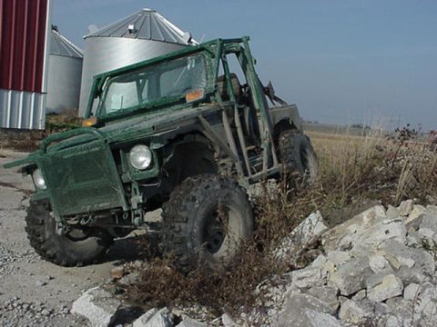 1992 Ford Bronco - This off-road vehicle appears to be modified for terrain, with a prominent roll cage and large tires.