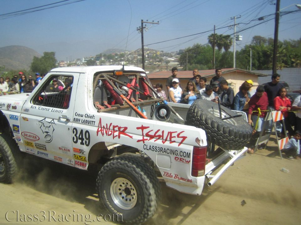 White off-road race truck #349 Anger Issues with spare tire racing on dirt