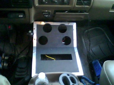 1995 Ford Bronco - Interior view of a vehicle's center console, a custom-built unit with multiple cup holders and exposed wiring.