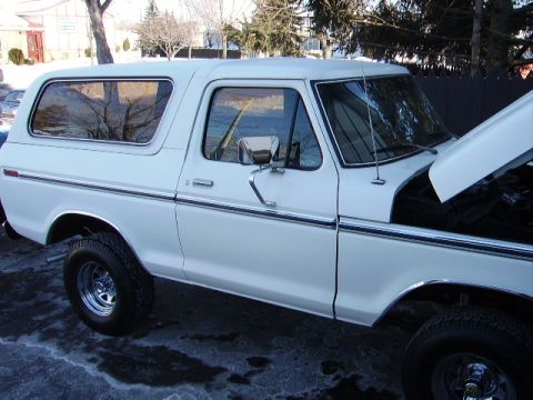 1978 Ford Bronco - This 1978 Ford Bronco is shown from the side with its hood open, revealing the engine bay.