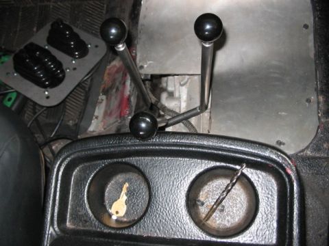 1991 Ford Bronco - Interior view of a vehicle's center console with shifters, cup holders, and pedals visible.