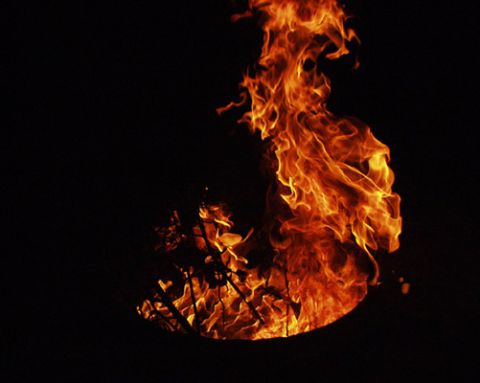 2000 Ford Crown Victoria - A dramatic scene of intense fire against a black background, with a website address visible.