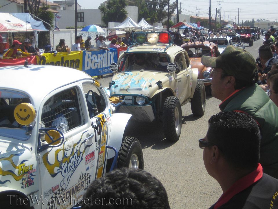 Off-road racing VW Beetle Class 11 cars staged in a line with spectators