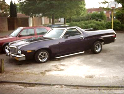 1973 Ford Ranchero - A 1973 Ford Ranchero in a deep purple hue is parked next to a red car, prominent chrome accents and side pipes.
