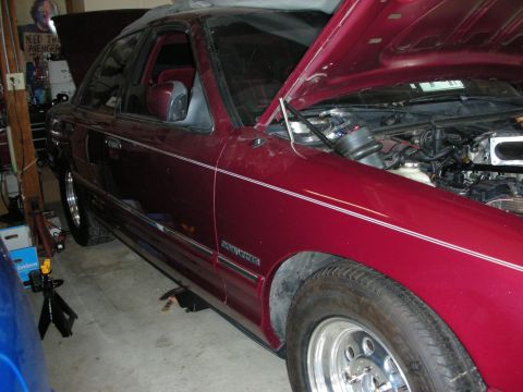 1992 Ford Crown Victoria - Maroon 1992 Ford Crown Victoria in garage, hood up, on jack stands.