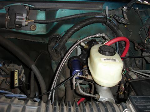 1996 Ford Bronco - Close-up view of engine bay components, including the brake fluid reservoir and master cylinder.