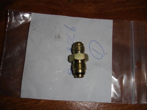 1996 Ford Bronco - A brass fitting is shown on a piece of paper with handwritten markings.