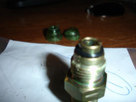 1996 Ford Bronco - Close-up of a metal fitting, likely a hydraulic component, with a black o-ring seal visible.