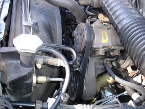 1996 Ford Bronco - The engine bay features a serpentine belt system driving various components, including the air conditioning compressor.