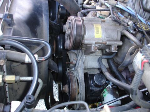 1996 Ford Bronco - Close-up view of the engine bay of a 1996 Ford Bronco, showing various components and hoses.