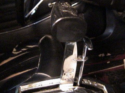 1977 Ford Mustang - Close-up view of an aftermarket shifter, likely installed in a vehicle's interior.