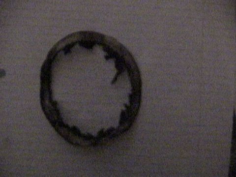 1977 Ford Mustang - Close-up of a damaged brake seal, likely from a vehicle's braking system.
