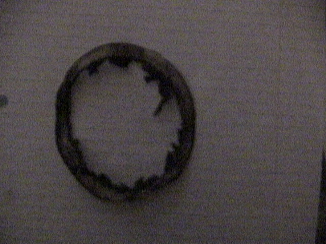 Worn rubber brake seal with visible damage on the inner edge