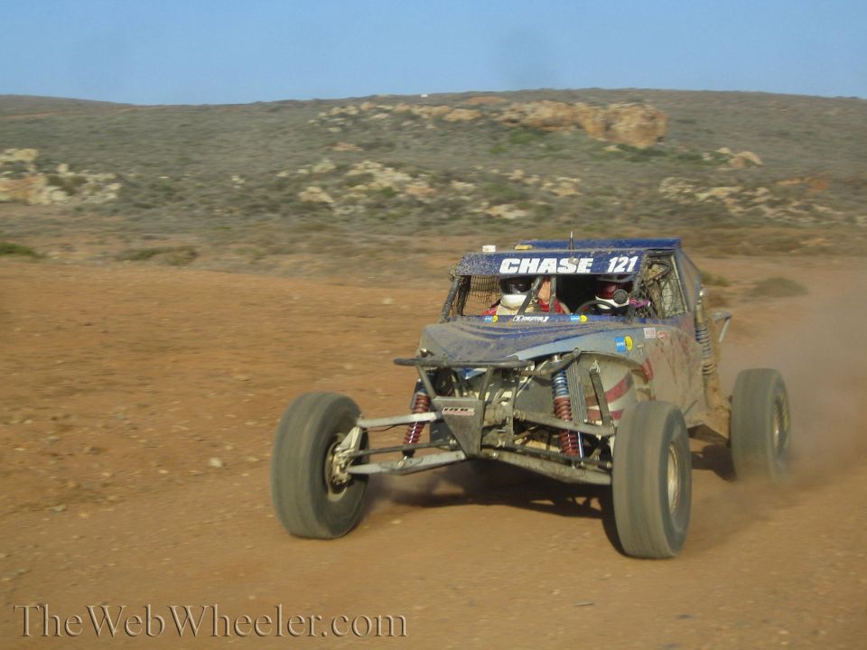 Front view of Chase 121 off-road buggy racing across desert dirt