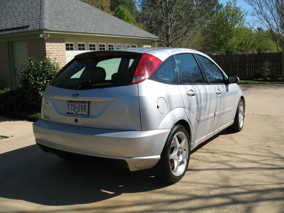 Silver hatchback parked in driveway, rear view. License plate Y70-DVR