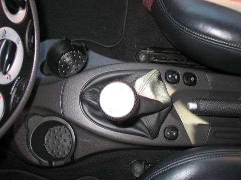 1993 Ford Bronco - Interior view of a car's center console with a manual gear shift and cup holders.