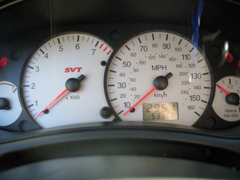 1993 Ford Bronco - Dashboard gauges display speed, RPM, and mileage, with an SVT badge visible on the tachometer.