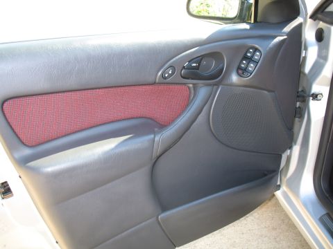 1993 Ford Bronco - Close-up of a car's interior door panel, showing the armrest and window controls.