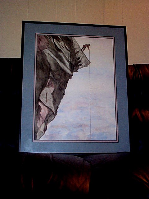 1994 Ford Probe - A framed painting depicts a lone climber scaling a steep cliff.