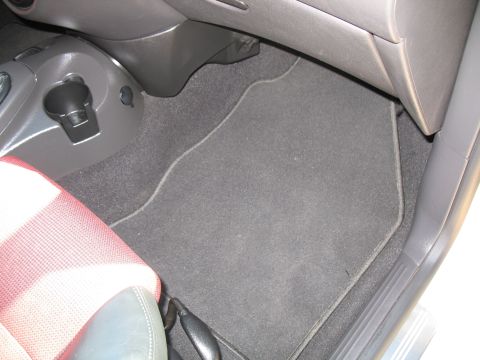 1993 Ford Bronco - Interior view of a car's floor mat and passenger seat.