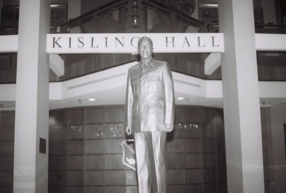 Statue of a man in uniform in front of Kisling Hall